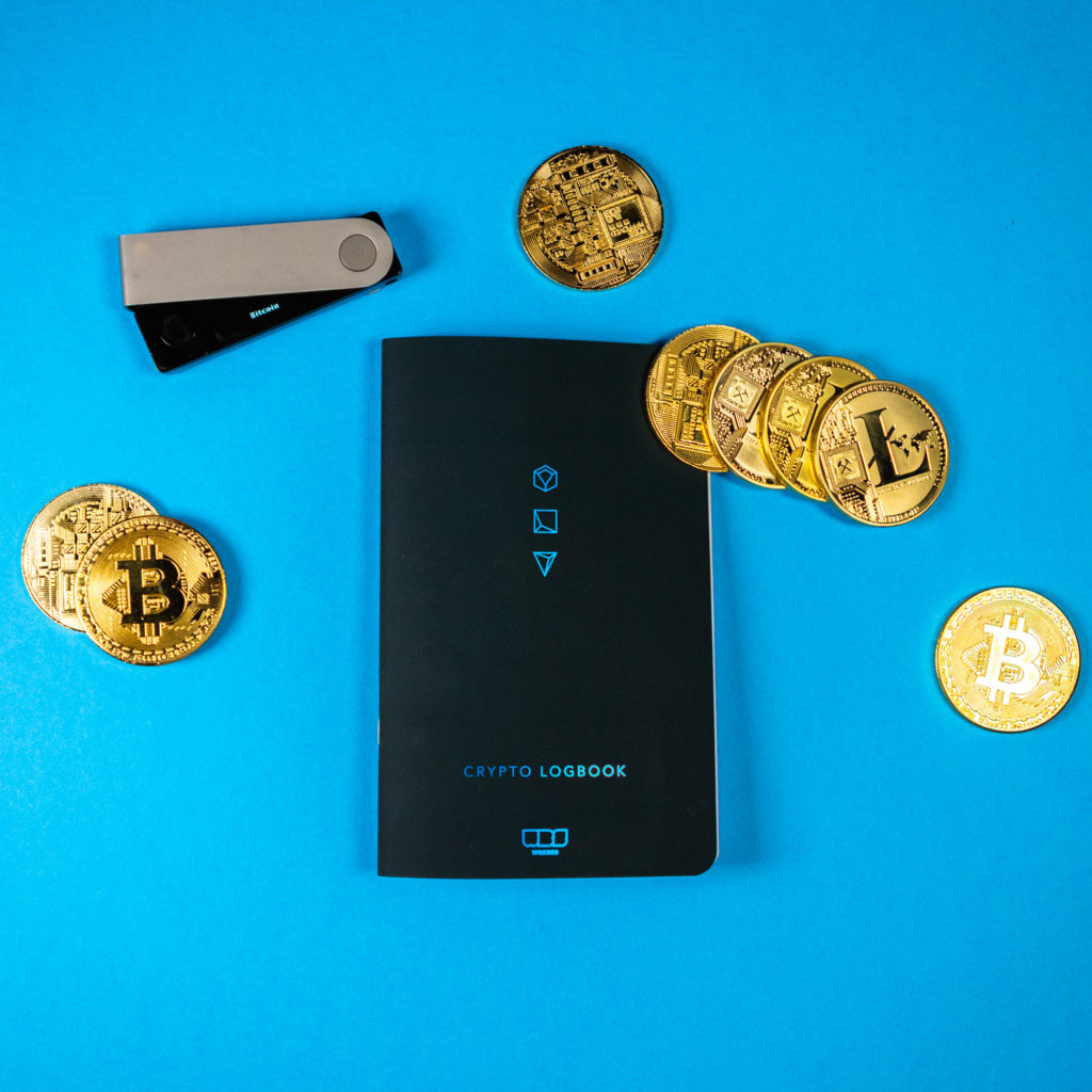 The cover of the crypto log with crypto coins around